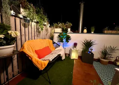 a patio with a chair on a fence with plants at Duplex 2 with quiet terrace on Wenceslas Square in Prague