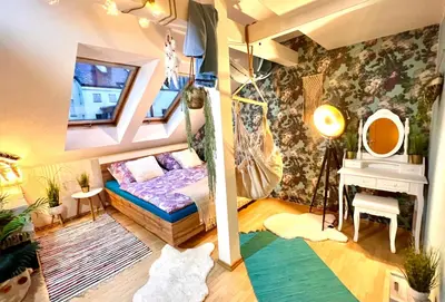 a small room with a bed and a mirror at Duplex 2 with quiet terrace on Wenceslas Square in Prague