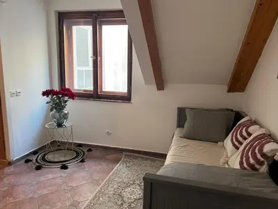 a bedroom with a bed and a vase of flowers at Old Town Square Apartments in Prague