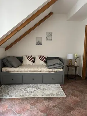 a bed in a living room with at Old Town Square Apartments in Prague