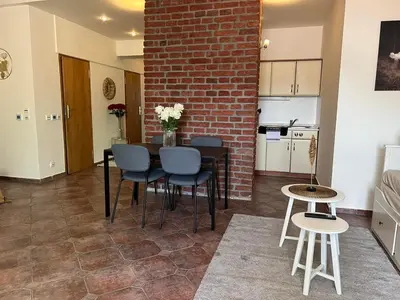 a room with a table and chairs and a brick wall at Old Town Square Apartments in Prague
