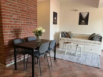 a living room with a table and chairs and a couch at Old Town Square Apartments in Prague