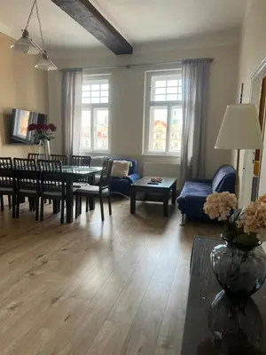 a living room with a couch and a table and chairs at Old Town Square Apartments in Prague