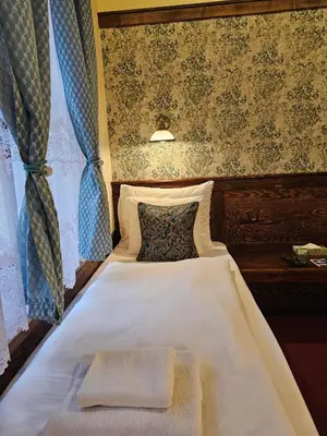 a bed with two towels on it in a bedroom at Hotel Galerie in Roudnice nad Labem