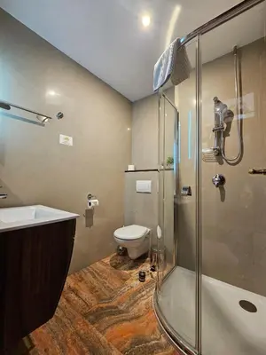 a bathroom with a shower and a toilet and a sink at Hotel Galerie in Roudnice nad Labem