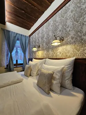 a bedroom with a large bed with white pillows at Hotel Galerie in Roudnice nad Labem