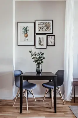 a dining room with a black table and blue chairs at TurnKey I King George Square Studio in Prague