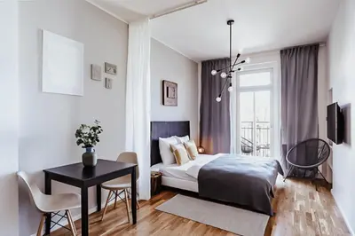 a bedroom with a bed and a table and chairs at TurnKey I King George Square Studio in Prague