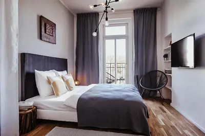 a bedroom with a large bed and a window at TurnKey I King George Square Studio in Prague