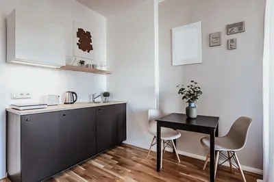 a small kitchen with a table and a desk at TurnKey I King George Square Studio in Prague