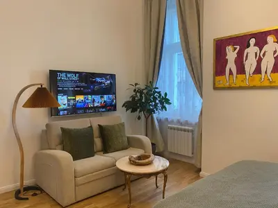 a living room with a couch and a table at NaNa Flat in Prague