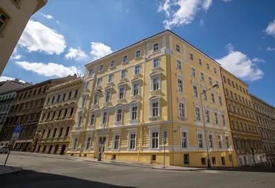 a yellow building on the side of a street at NaNa Flat in Prague