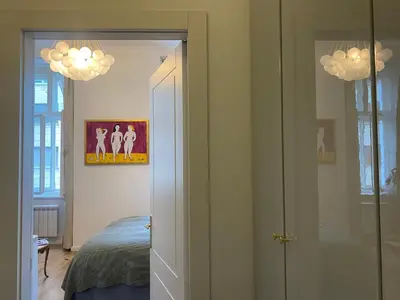 a bedroom with a bed and a painting on the wall at NaNa Flat in Prague