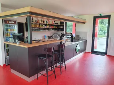 a bar with two stools at a counter in a restaurant at Penzion na hřišti in Radím