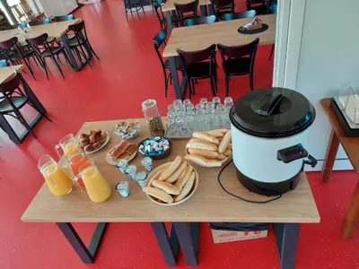 a table with food and a coffee maker on it at Penzion na hřišti in Radím