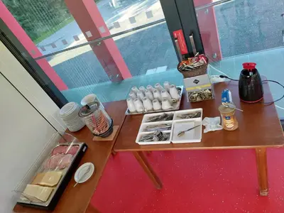 a table with food and drinks on it next to a window at Penzion na hřišti in Radím