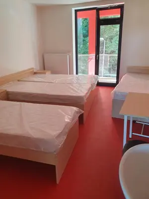 a room with two beds covered in plastic at Penzion na hřišti in Radím