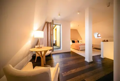 a hotel room with a bed and a table and chairs at LUX Penthouse Apartments near Wenceslas Square in Prague