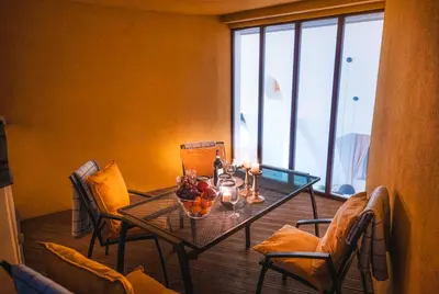 a table with a bowl of fruit and candles on it at LUX Penthouse Apartments near Wenceslas Square in Prague
