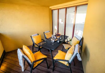 a dining room with a table and chairs on a balcony at LUX Penthouse Apartments near Wenceslas Square in Prague