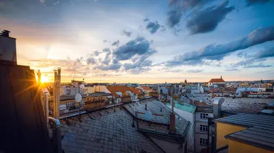 a view of a city with the sun setting at LUX Penthouse Apartments near Wenceslas Square in Prague