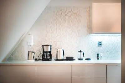 a kitchen with a counter top with appliances on it at LUX Penthouse Apartments near Wenceslas Square in Prague