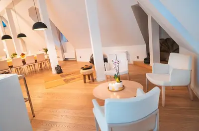 a living room with a table and white chairs at LUX Penthouse Apartments near Wenceslas Square in Prague