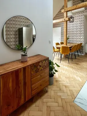 a dining room with a mirror and a table at Štupartská - Attic Old Town Residence in Prague