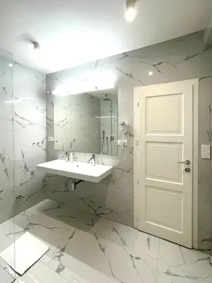 a bathroom with a sink and a mirror at Štupartská - Attic Old Town Residence in Prague