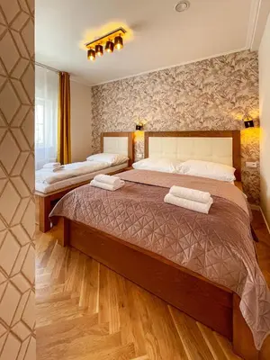 a bedroom with a large bed in a room at Štupartská - Attic Old Town Residence in Prague