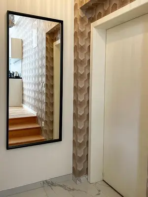 a mirror on the wall of a hallway with a staircase at Štupartská - Attic Old Town Residence in Prague