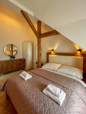 a bedroom with a large bed with two towels on it at Štupartská - Attic Old Town Residence in Prague