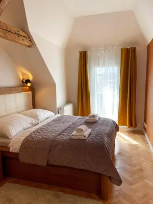 a bedroom with a bed with two towels on it at Štupartská - Attic Old Town Residence in Prague
