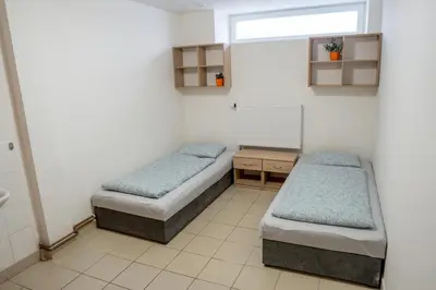 a room with two beds and a window at Penzion Pomeranč in Louny