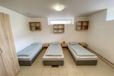 a hospital room with three beds and a window at Penzion Pomeranč in Louny