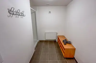a hallway with a wooden bench in a room at Penzion Pomeranč in Louny