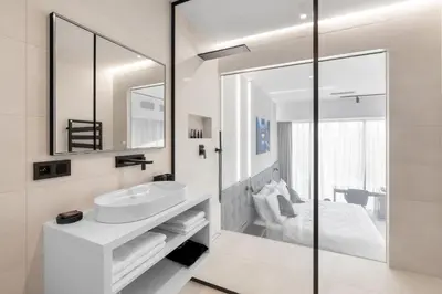 a white bathroom with a sink and a mirror at Port Karolina Luxury Residence in Prague