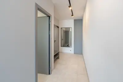 a hallway with white walls and a mirror at Port Karolina Luxury Residence in Prague