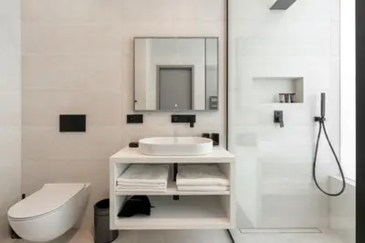 a bathroom with a sink and a toilet and a mirror at Port Karolina Luxury Residence in Prague