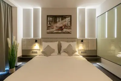 a bedroom with a large white bed with white pillows at Port Karolina Luxury Residence in Prague