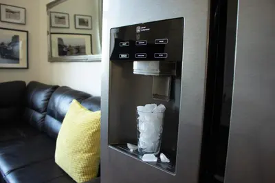 a drink dispenser in a room with a couch at Double King Size Sunny Suite In Castle Area in Prague