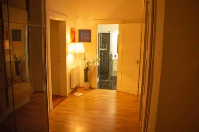 a hallway with a mirror and a door to a bathroom at Double King Size Sunny Suite In Castle Area in Prague