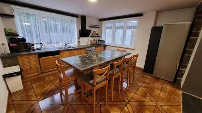 a kitchen with a table and chairs in a room at Wellness Aqua House in Prague