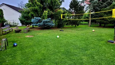 a backyard with a volley ball hoop in the grass at Wellness Aqua House in Prague