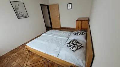 a bed in a room with two pillows on it at Wellness Aqua House in Prague