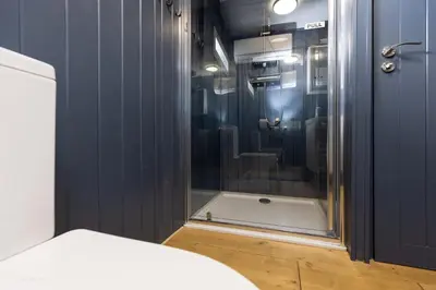 a bathroom with a shower with a glass door at Houseboat - best place in Prague in Prague