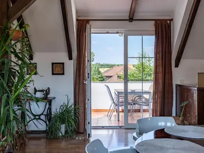 a living room with a sliding glass door leading to a patio at Holiday Home Řevnice by Interhome in Řevnice