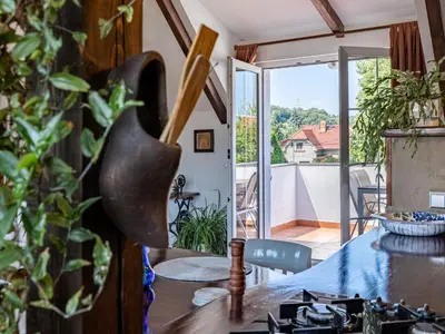 a dining room with a table and a view of a balcony at Holiday Home Řevnice by Interhome in Řevnice