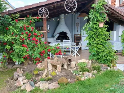 a garden in front of a house with flowers at Holiday Home Řevnice by Interhome in Řevnice