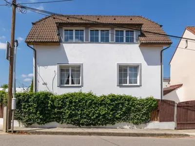 a white house with a brown roof at Holiday Home Řevnice by Interhome in Řevnice